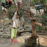 Little Girl Participating in Village Life