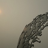 Olympic Flame  This sculpture in Beijings olympica park symbolizes the olympic flame, bakced by the sun which barely manages to shine through the polluted air.