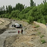 Car Wash - Uighur Style  What to do on a lazy sunday afternoon? Well, why not give a wash to your car? While most people would take their car to an acutal car wash or unroll the hosepipe on their frontyard to do so, Uighurs seem to just drive their car to the next river. Or rather: into the river. An while daddy brushes the car, the family has a nice little pick-nick on the riverbank.