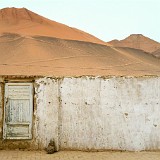 Gateway Between East and West  The silk road has been a gateway between the east and the west for thousands of years. This doorway in the area of Turpanl, seemingly leading to nowhere but the desert dunes, seemd to be a perfect symbol for that.