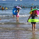China Beachlife  A very commen sight on beaches in China: (1.) Parasol, because Chinese don't like to be tanned, (2.) swim ring, becuase many chinese can't swim, (3.) dress or long clothes, against the sun, and because one doesn't want to look too sexy - many Chinese are still quite prudish.