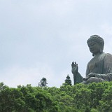 Big Buddha on Lantau Island  The Big Buddha on Lantau Island has become a major tourist attaraction - to go there on a weekend you'll have to queue up for the cable car for 2 hours... (or, if you have a local source of information, take the bus with zero waiting time :-). After a six month tour through buddhist territory one is not easily impressed by buddha statues anymore - still, this one looke nice from this perspective, like sitting on a cloud of trees...