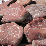 Prayer Stones  These stones with engraved mantras are stacked around holy places, with the idea that the mantras (prayers) are caught by the wind and carried away.