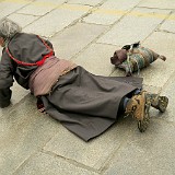 Prostrating Pilgrim at Jokhang Temple  Prostration is the most devoted way of pilgrimage - some of the pilgrims come from hundreds of kilometers away to Lhasa, prostrating (i.e. laying down on the ground in awe) the whole way, so it takes the months or even years to reach their destination.