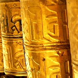 Prayer Wheels  All the Koras (the pilgrim trails around the holy places) are aligned with countless prayer wheels, which are being turned by the pilgrims in order to send the mantras, which are placed inside the wheels, towars the skies.