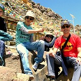 Our Travel Group  Our tour group, on the left the German couple Anne and Markus, our guide Pasang in the center, and Peter and I on the right. Missing is Hari, who is taking the picture. In the background is the endless line of prayer wheels on the Kora around the Tashilhunpo Monastery in Shigatse.