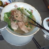 Pho Bo  This is the mother of all vietnamese dishes, rice noodle soup ("pho") with fresh herbs and beef ("bo"). It is eaten at all times of the day, but particularly popular for breakfast.