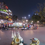 Hanoi Street Life 4  In Vietnam, everything is transported with a motorbike, and everything is sold from a bicycle, so why not hats? At least they make for a good foto target in front of the Hanoi night lights...