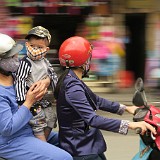 Hanoi Street Life 3  In Vietnam, stree life is family lilfe, as can be seen here, where presumably three generations cruise the city on two wheels.
